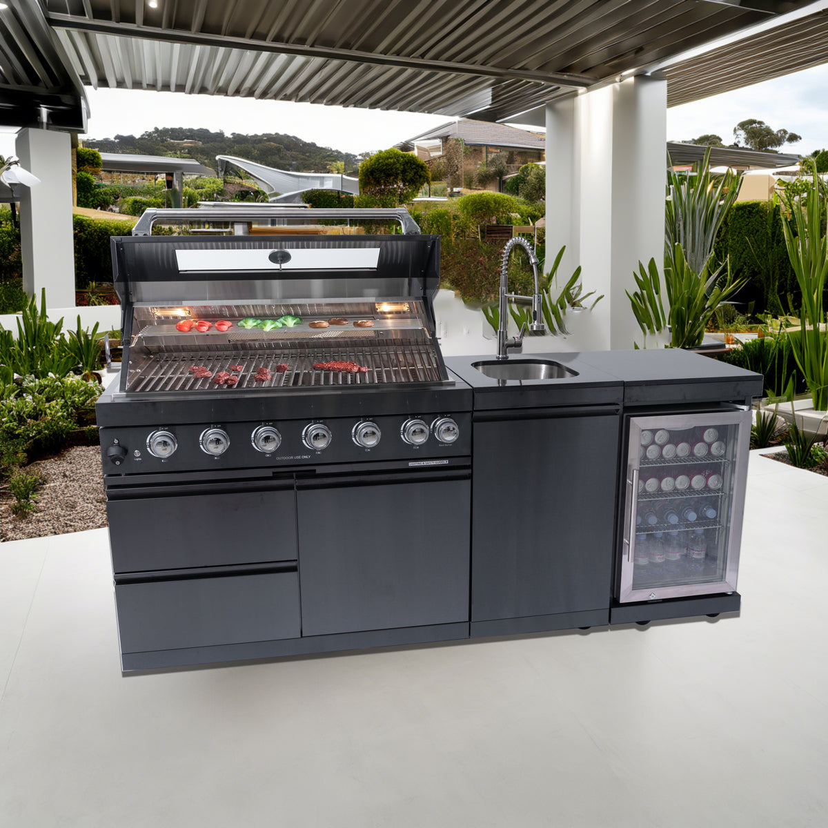 Black stainless steel outdoor kitchen installed on modern patio with grill and sink.